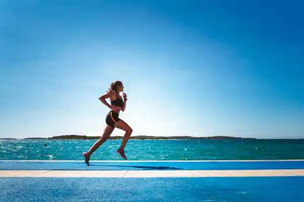 Woman running showing strong leg muscle Kelvindale